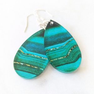 Vibrant teal and green marbled earrings with layered wave patterns, laid flat on a white background.
