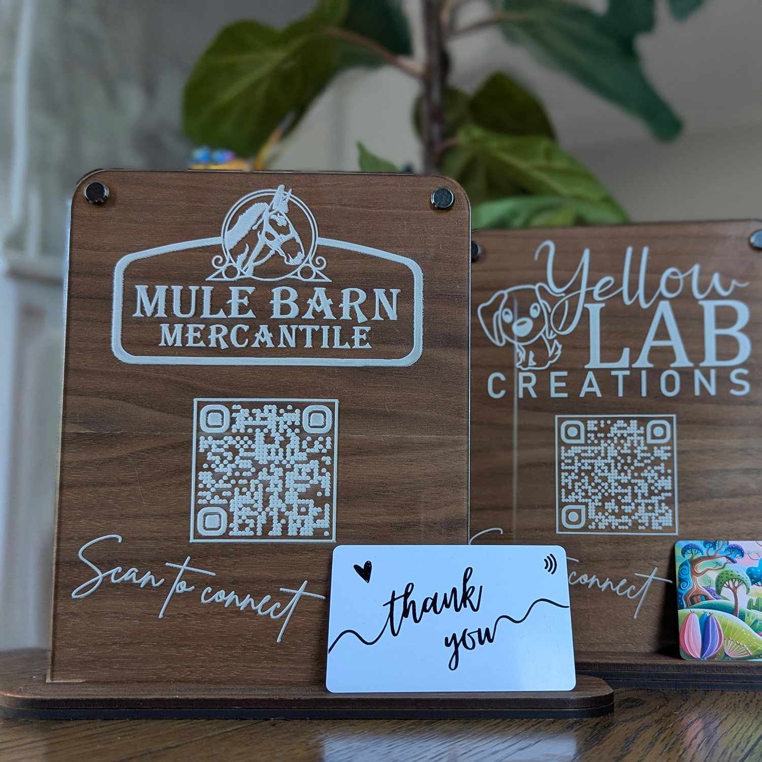 Wooden signs displaying QR codes and thank you card.